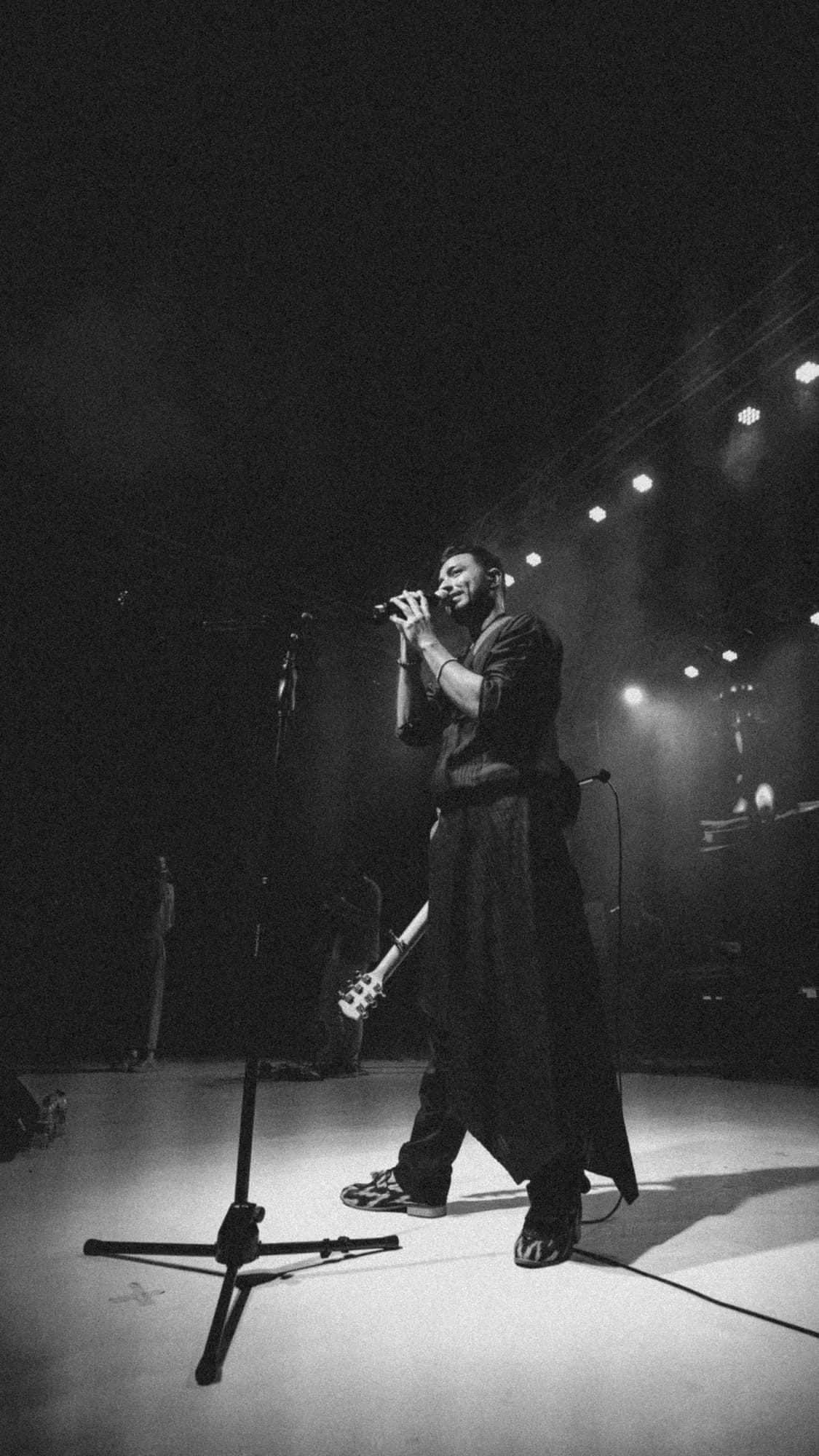 Black-and-white photograph of a singer performing on stage